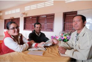 Norng Theourn, FWUC leader (right) meets with members to collect farmer contribution fees and prepare a monthly work plan.