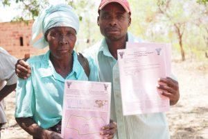 man and woman holding documents