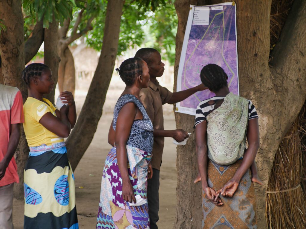 people standing looking at map