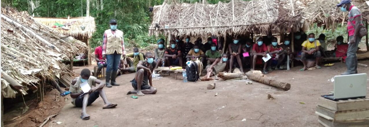 people seated on ground in village