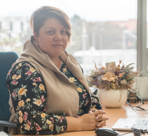 a woman sits in her office