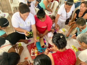 a group of women standing around a craft table