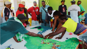 Community members reviewing a participatory map of their territory during a land-use and conservation planning discussion.