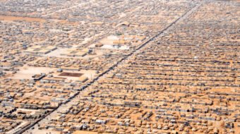 Aerial view of closely packed shelters and intersecting roads at Zaatari refugee camp in Jordan.
