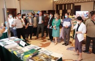 Participants view an exhibition at the 2022 responsible investment dialogue in Laos